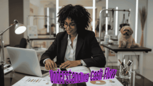 Pet grooming business owner reviewing cash flow statements at her desk with a dog on a grooming table in the background